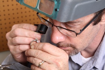 Jeweler Inspecting Benchmark Ring